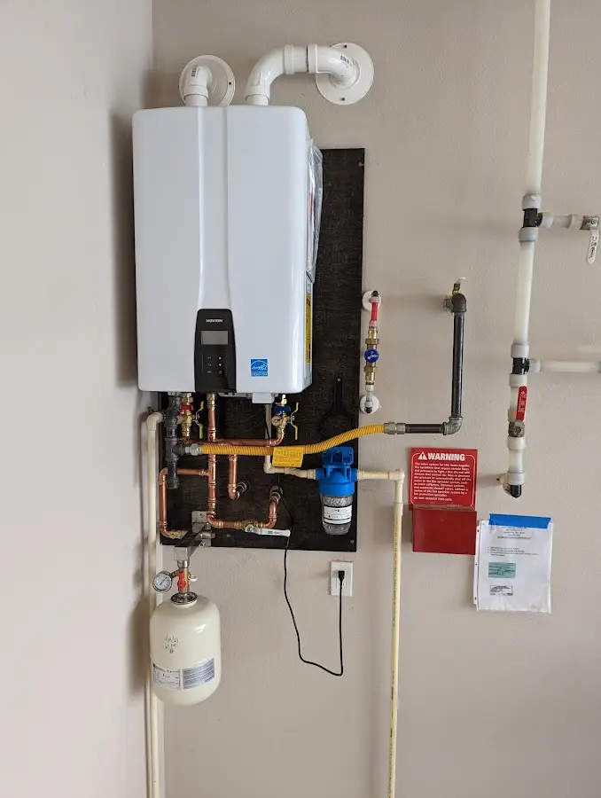 Professional plumber installing copper piping in a Manvel home